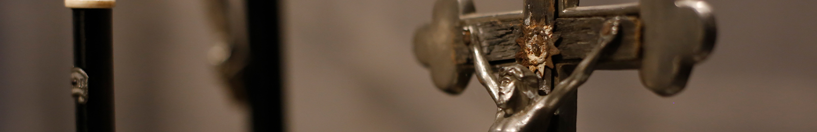 Cropped close-up of a silver crucifix.